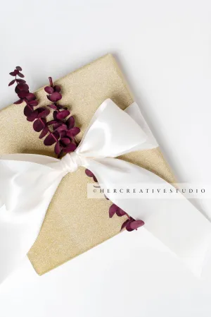 Gold Present with Burgundy Trimmings on White Background
