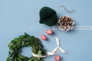 Green Ornament & Wreath on Sky Blue Background