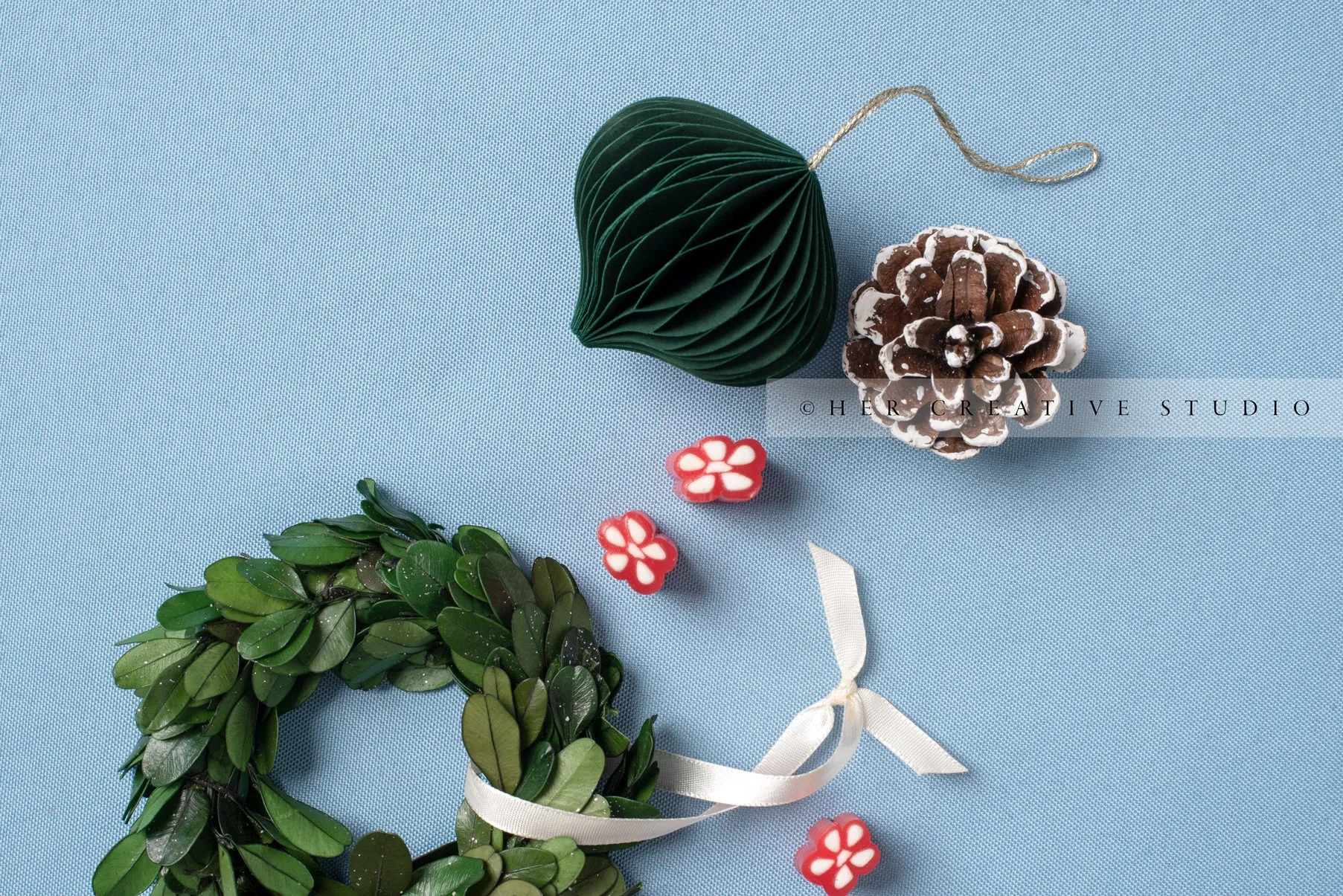 Green Ornament & Wreath on Sky Blue Background