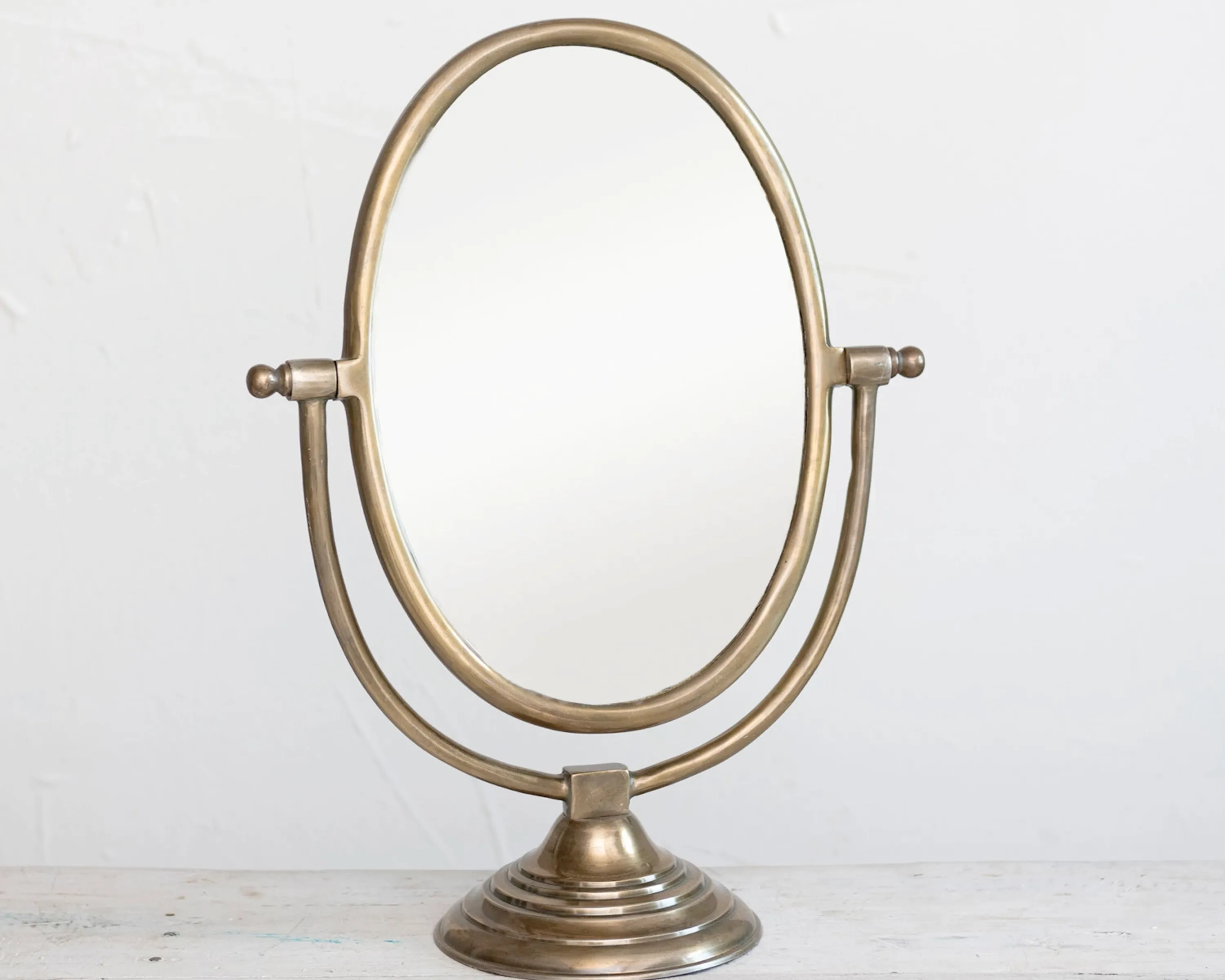 Large framed table mirror on antique brass stand