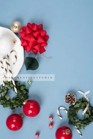Red Bow, Wreaths & Ornaments on Sky Blue Background