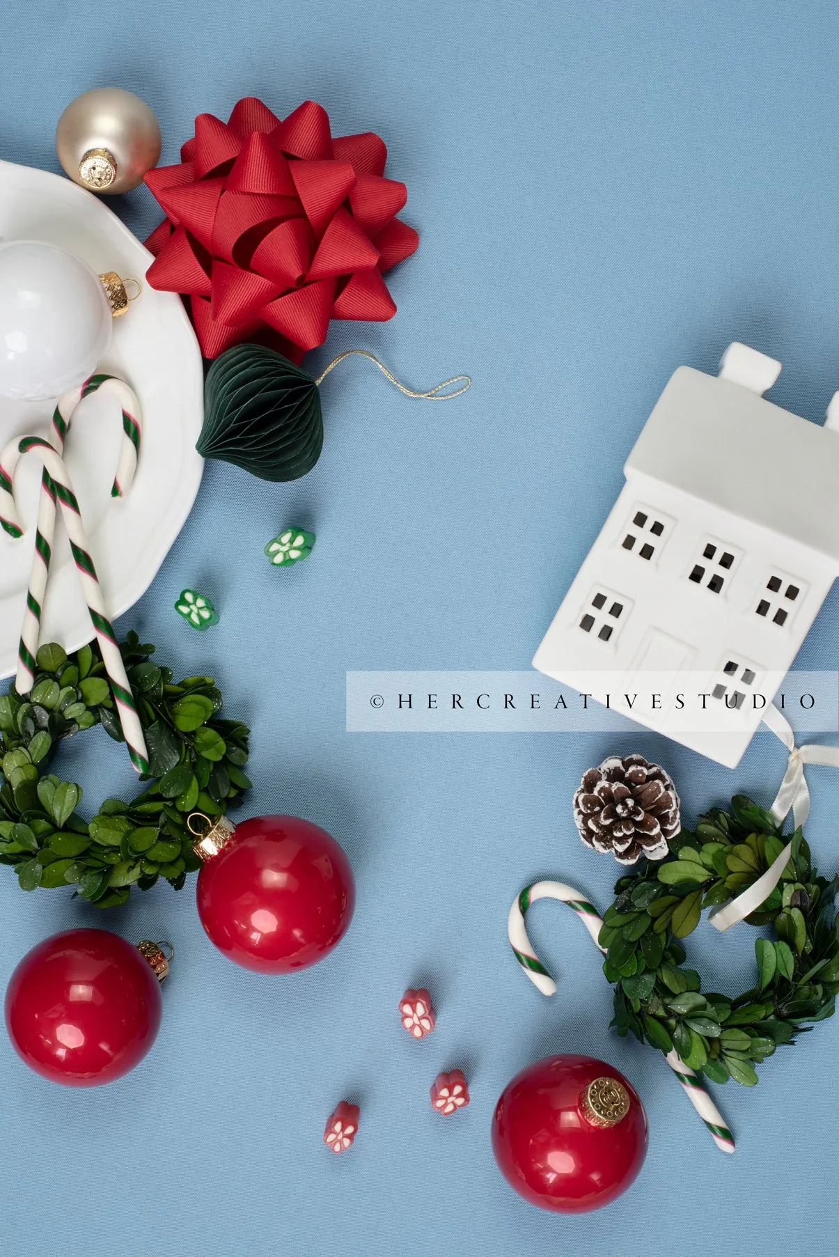 Red Ornaments, Holiday Home & Wreath on Sky Blue Background