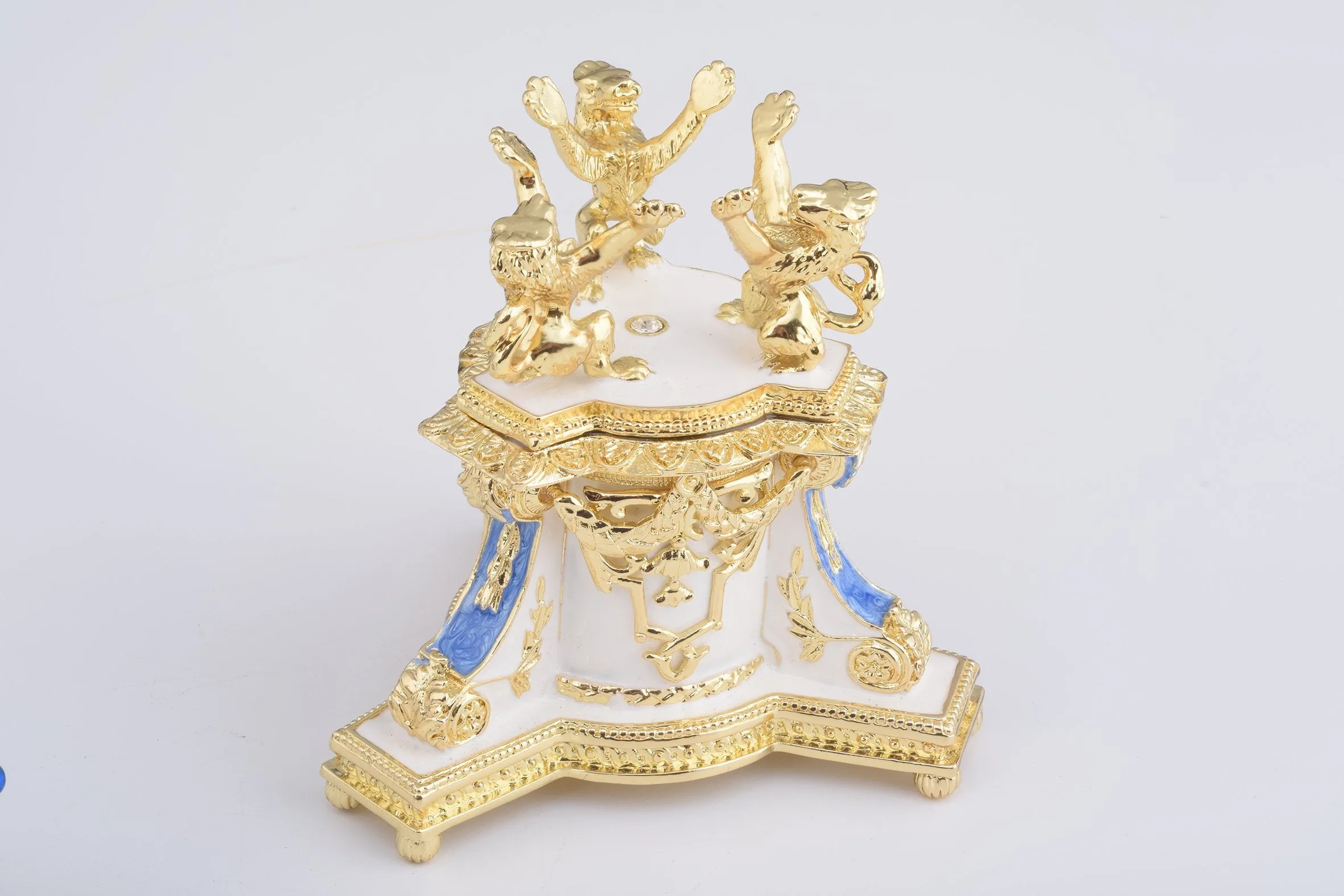 White Faberge Egg with an Elephant on Top
