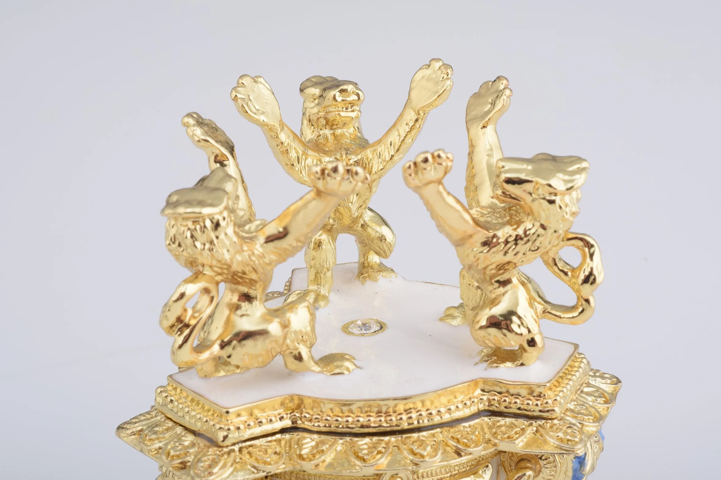 White Faberge Egg with an Elephant on Top