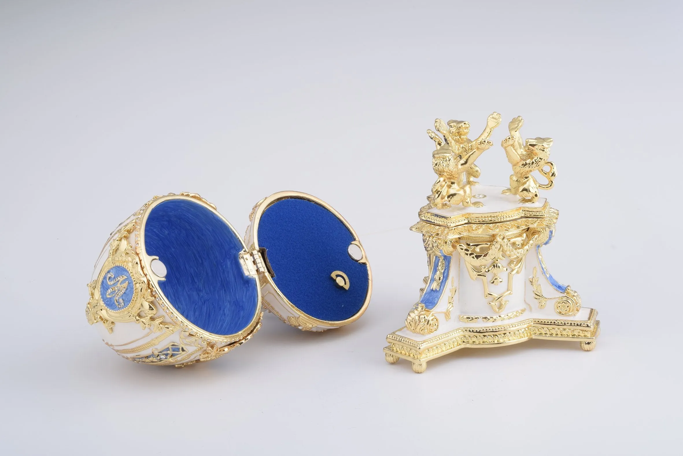 White Faberge Egg with an Elephant on Top