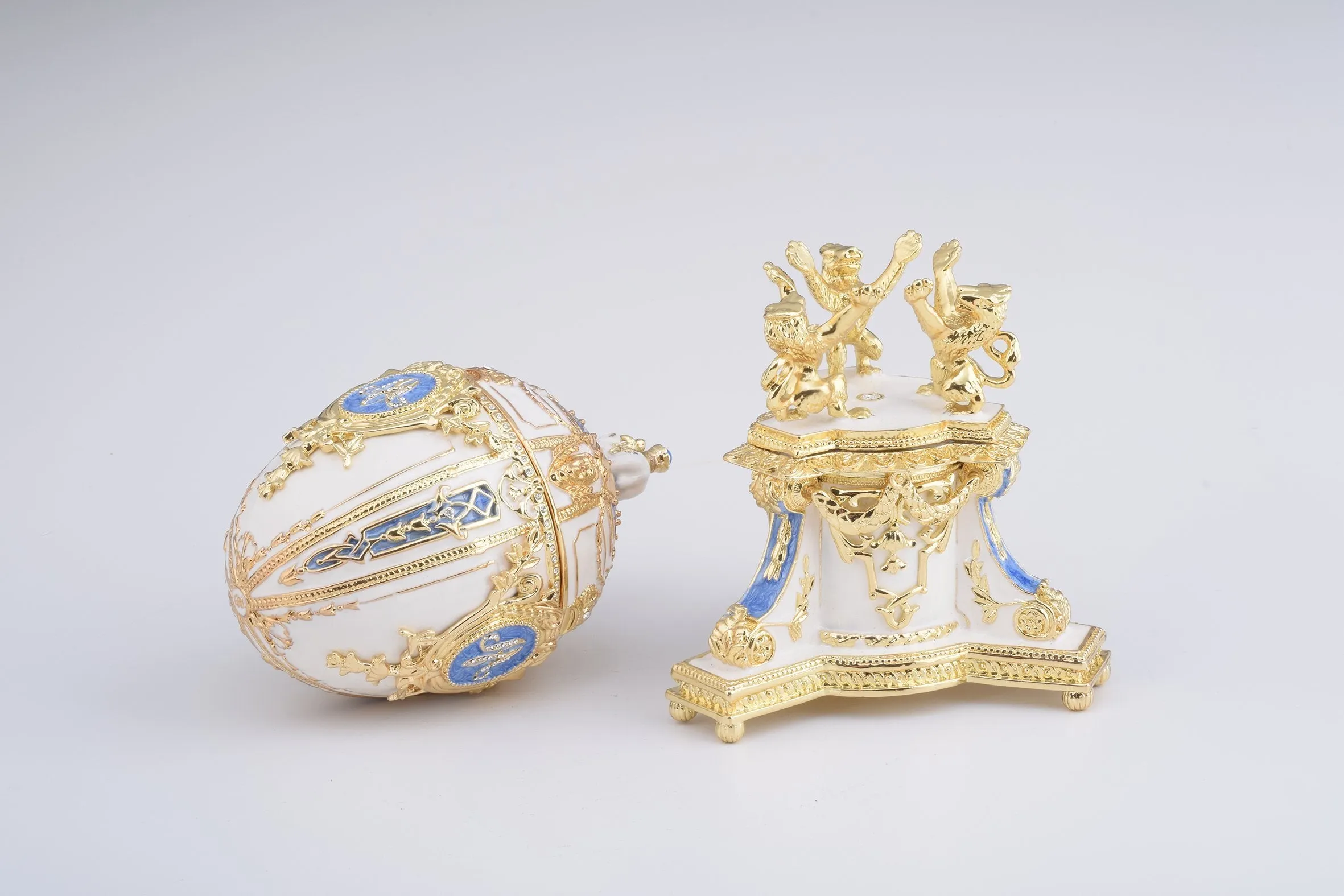 White Faberge Egg with an Elephant on Top