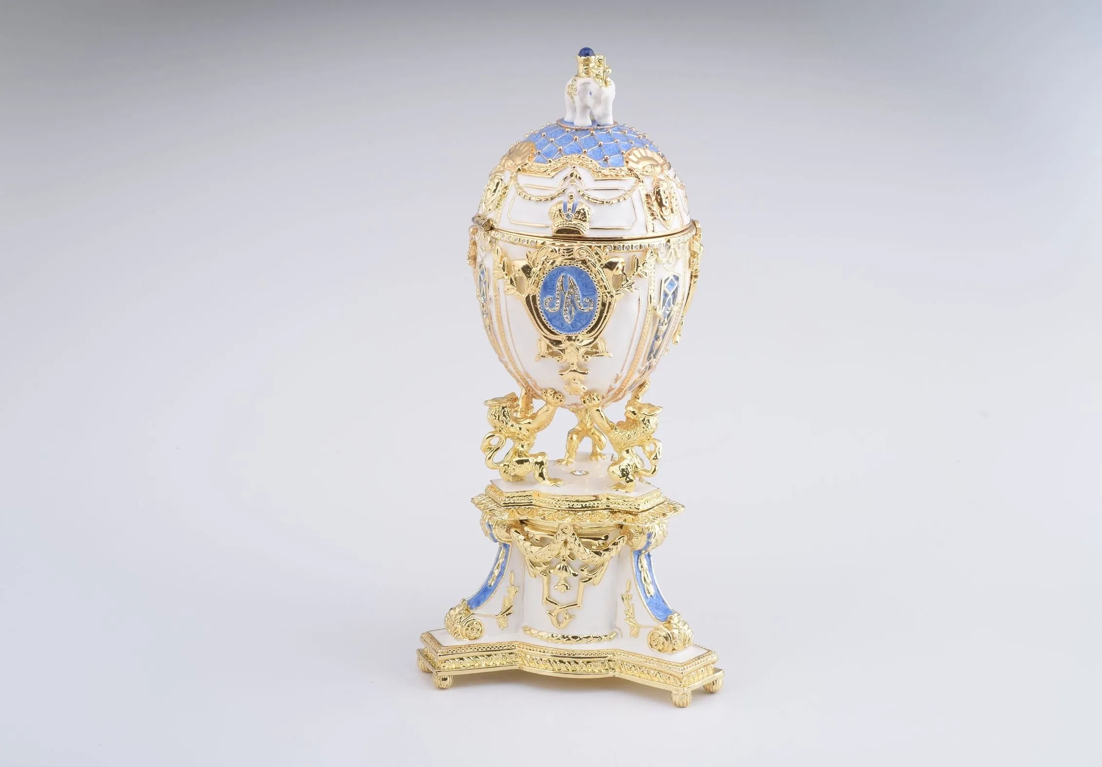 White Faberge Egg with an Elephant on Top