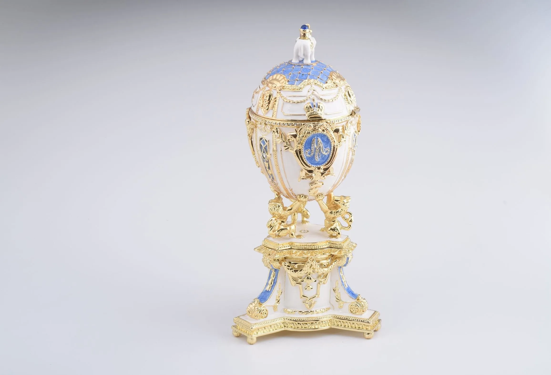 White Faberge Egg with an Elephant on Top