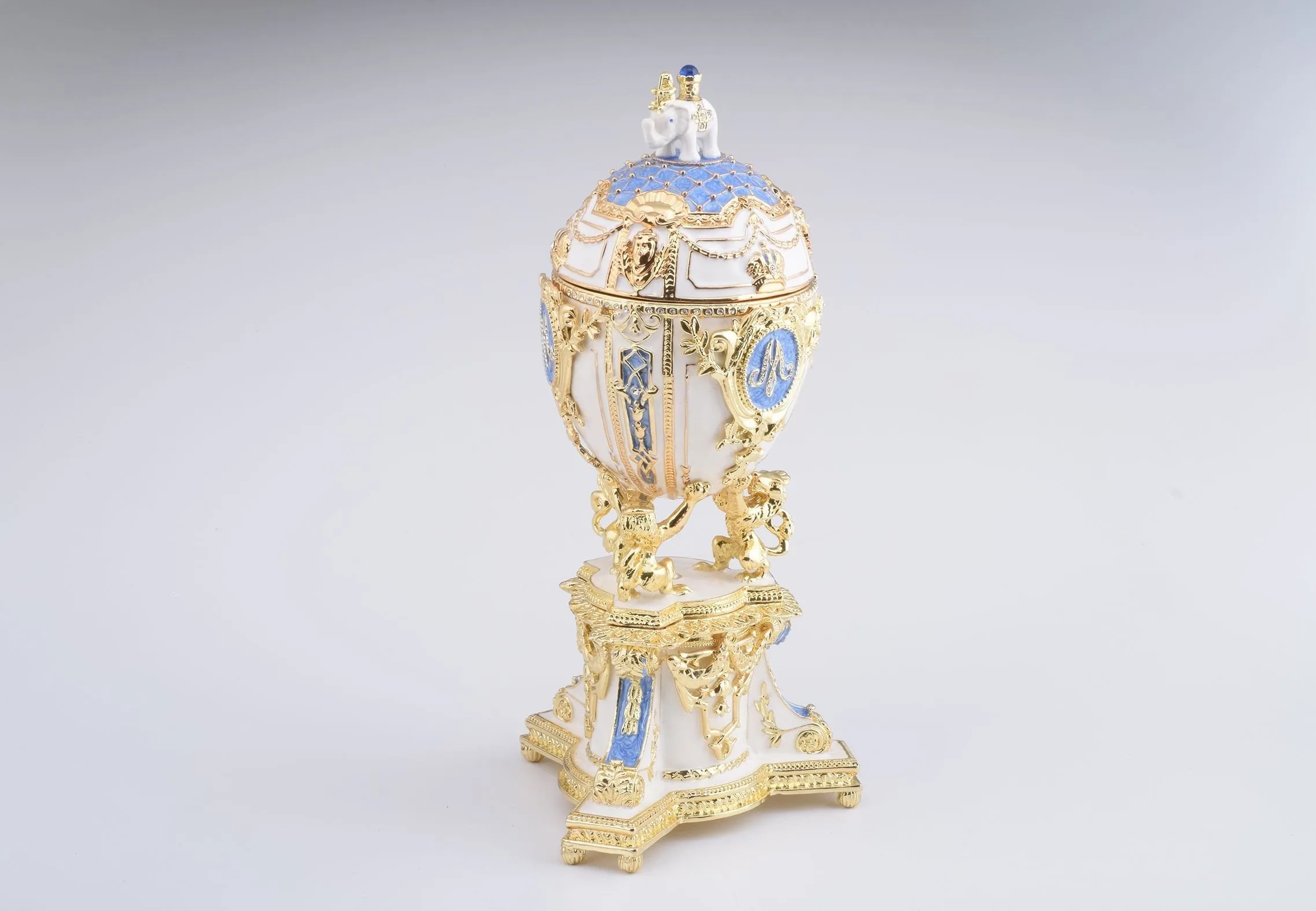 White Faberge Egg with an Elephant on Top