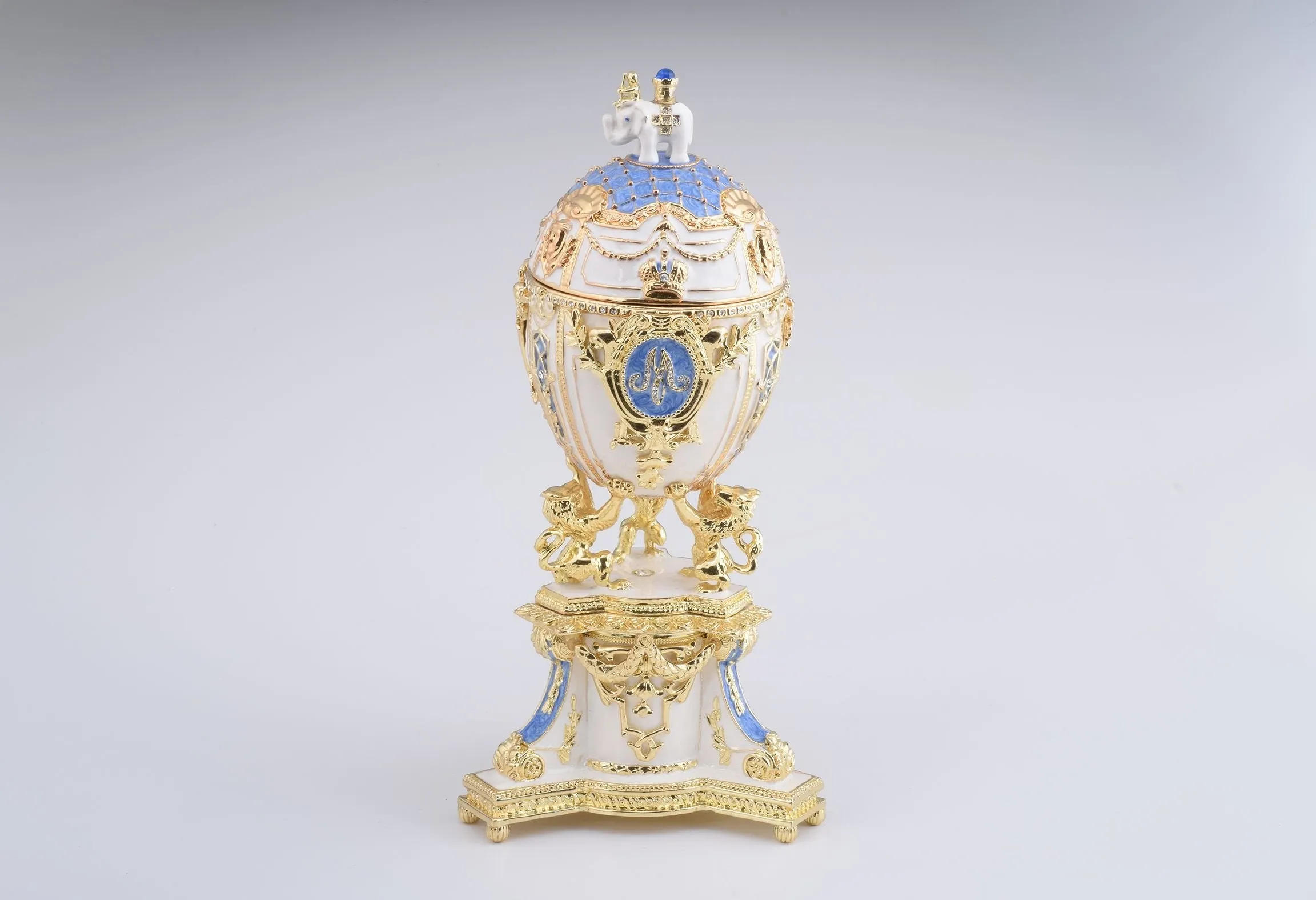 White Faberge Egg with an Elephant on Top