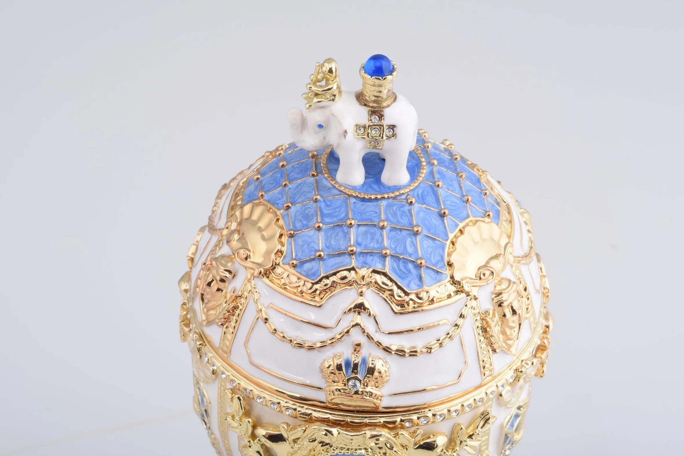 White Faberge Egg with an Elephant on Top