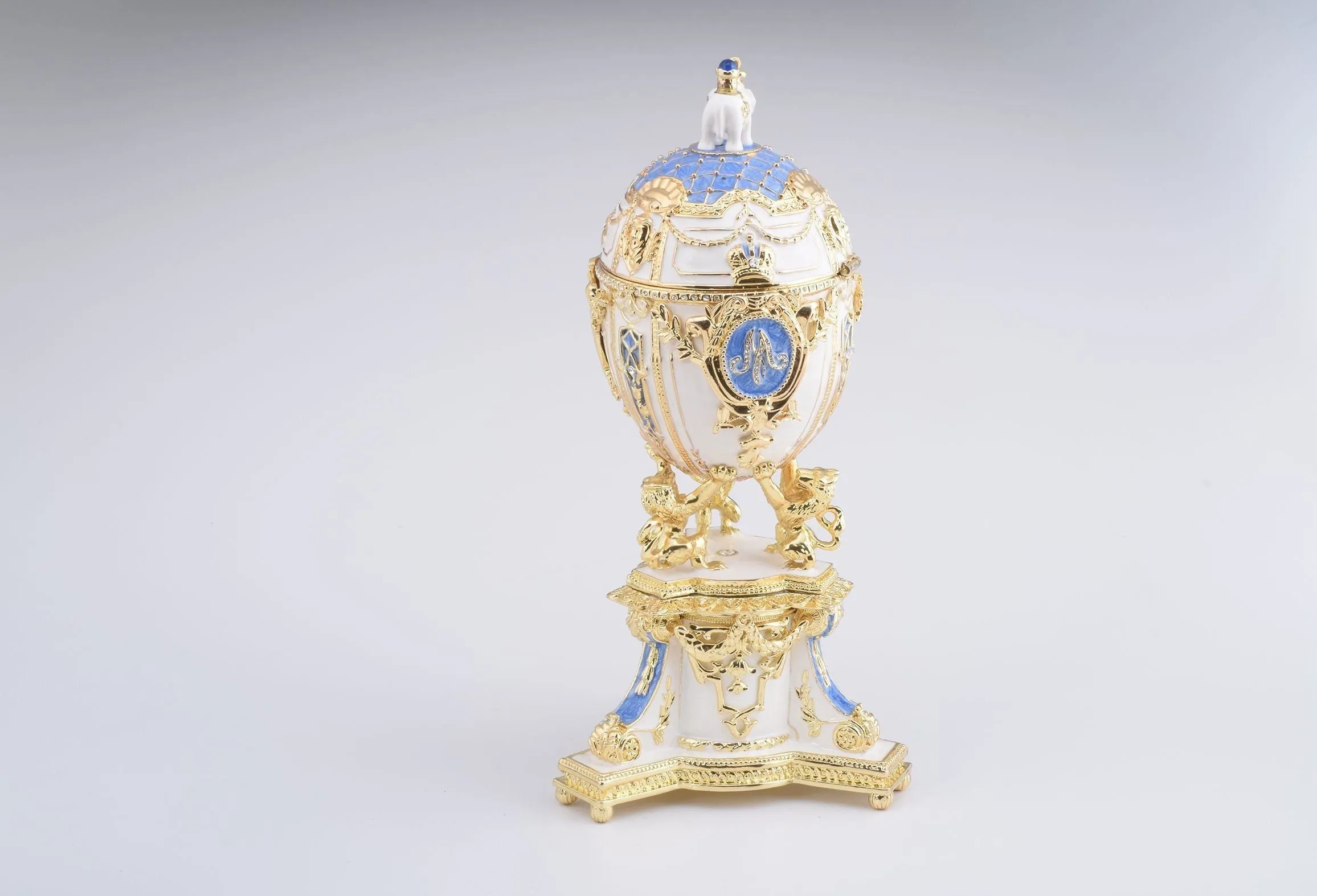 White Faberge Egg with an Elephant on Top