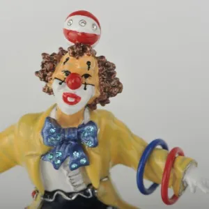 Yellow Circus Clown Juggling on Unicycle